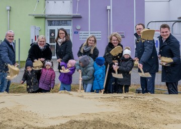 Schulamtsleiter Andreas Schmidt, Gemeinderätin Birgit Becker, Magdalena Spangl, Kindergartenleiterin Eva Stanic, Familien-Landesrätin Christiane Teschl-Hofmeister, Bürgermeister Matthias Stadler und Landtagsabgeordneter Florian Krumböck (v.l.n.r.) mit Kindern des Kindergartens beim Spatenstich